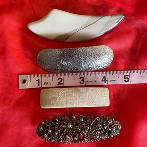 4 large hair clips of various styles.